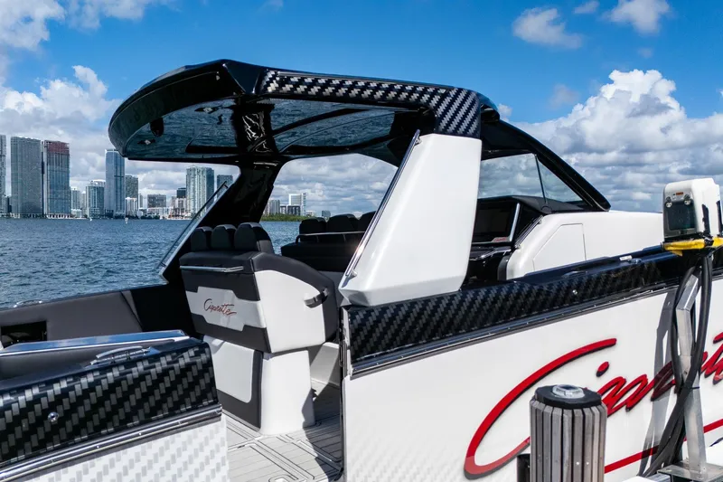  Yacht Photos Pics 2024 Cigarette 42 Auroris boat docked with city skyline in background.