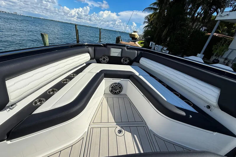  Yacht Photos Pics 2024 Cigarette 42 Auroris boat interior with luxurious seating and scenic waterfront view.