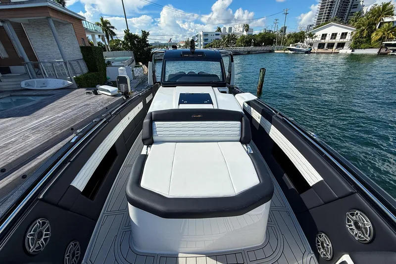  Yacht Photos Pics 2024 Cigarette 42 Auroris luxury boat docked by waterfront homes.