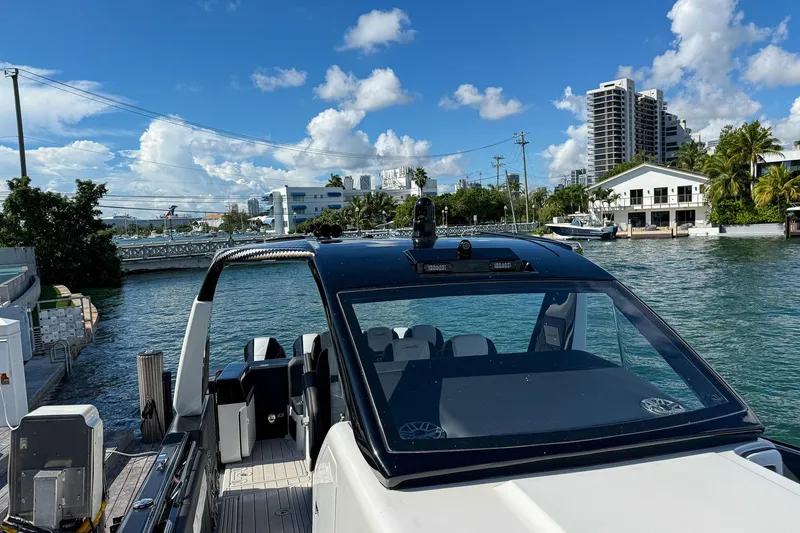  Yacht Photos Pics 2024 Cigarette 42 Auroris boat docked by waterfront, under clear blue sky.