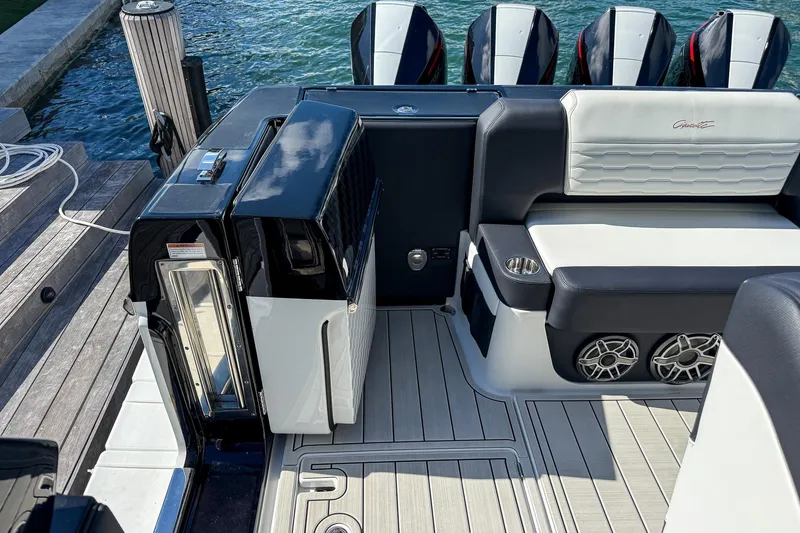  Yacht Photos Pics 2024 Cigarette 42 Auroris boat interior with seating, speakers, and outboard motors.