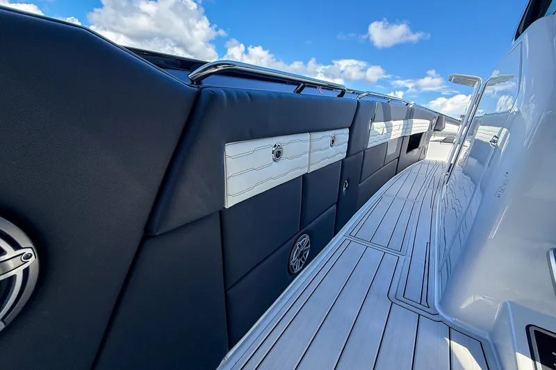  Yacht Photos Pics 2024 Cigarette 42 Auroris boat deck with sleek design and modern features under blue sky.