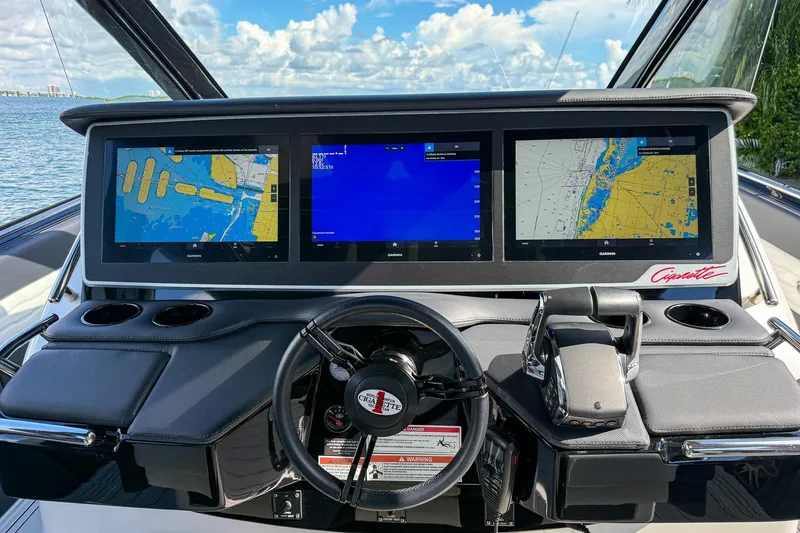  Yacht Photos Pics Dashboard of 2024 Cigarette 42 Auroris boat with navigation screens and steering wheel.