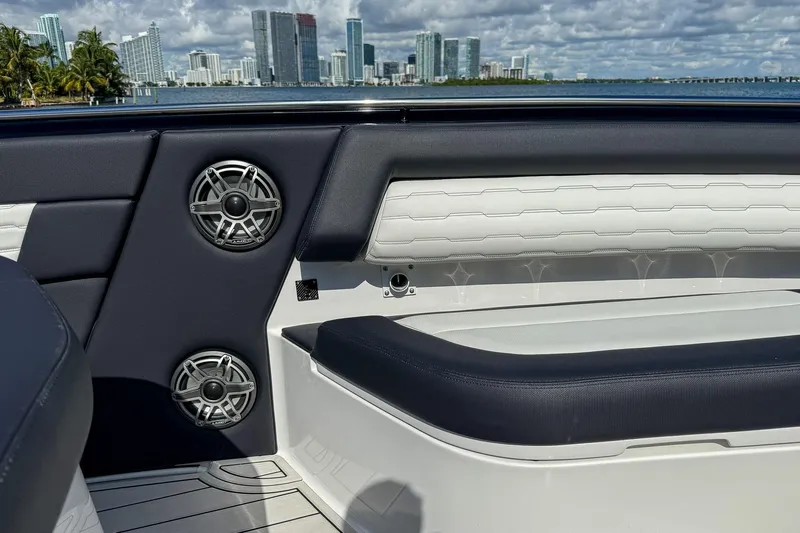  Yacht Photos Pics 2024 Cigarette 42 Auroris boat interior with speakers, luxury seating, and city skyline view.