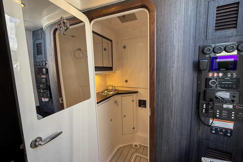  Yacht Photos Pics 2024 Cigarette 42 Auroris cabin interior with control panel and compact sink area.