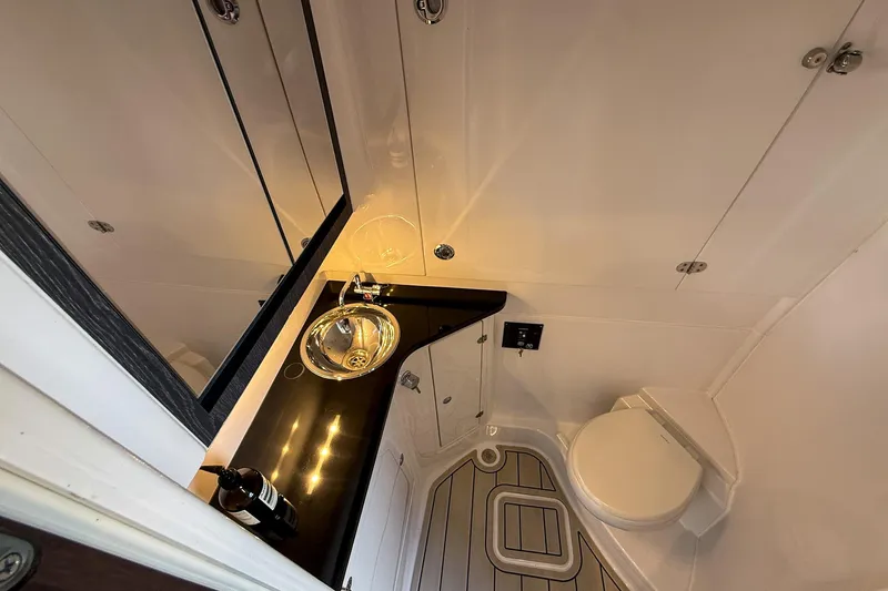  Yacht Photos Pics 2024 Cigarette 42 Auroris bathroom with sleek design, modern sink, and compact toilet.