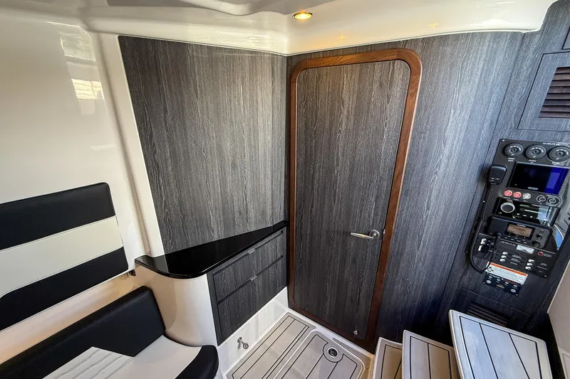  Yacht Photos Pics 2024 Cigarette 42 Auroris cabin interior with wood paneling and control panel.