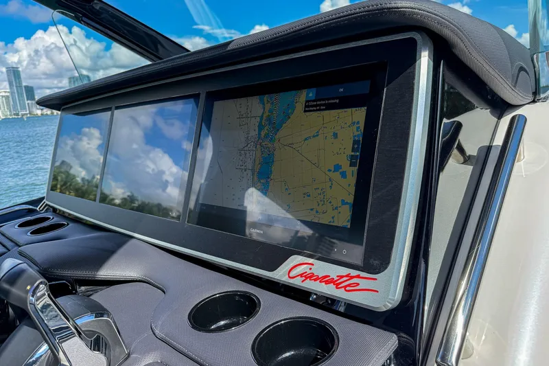  Yacht Photos Pics Dashboard of 2024 Cigarette 42 Auroris with navigation screens and city skyline view.