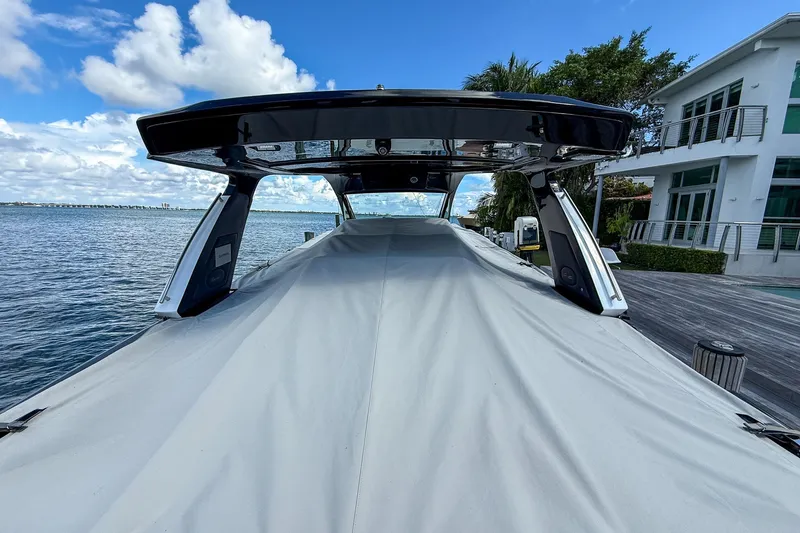  Yacht Photos Pics 2024 Cigarette 42 Auroris boat covered at dockside, with waterfront view.