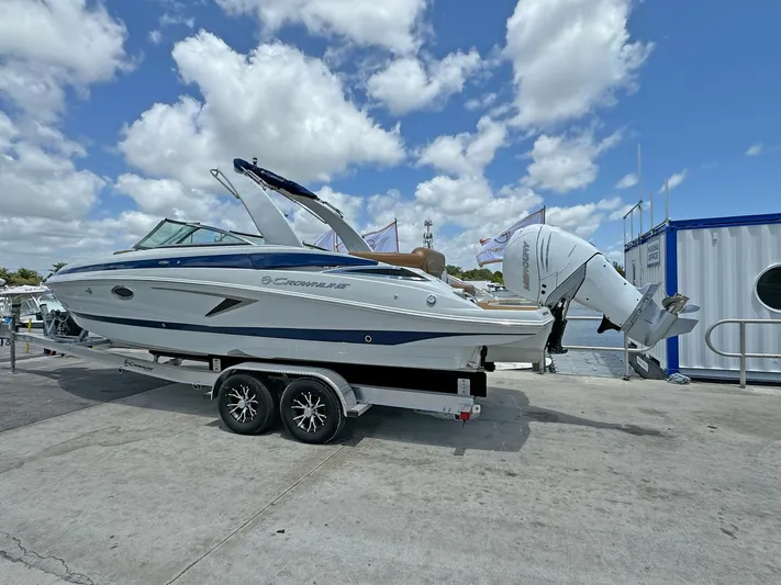  Yacht Photos Pics 2024 Crownline 290 XSS boat on trailer under cloudy sky at marina.