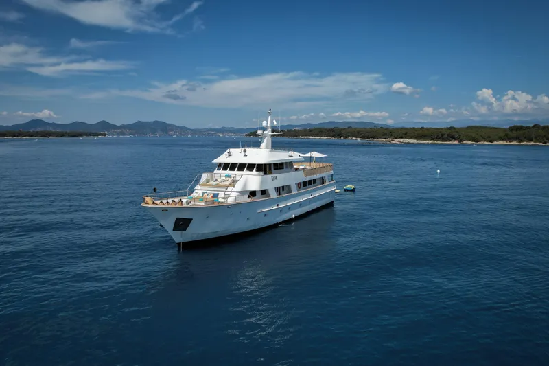 Eva Yacht Photos Pics Luxury 1993 Cheoy Lee Custom yacht on serene blue waters under a clear sky.