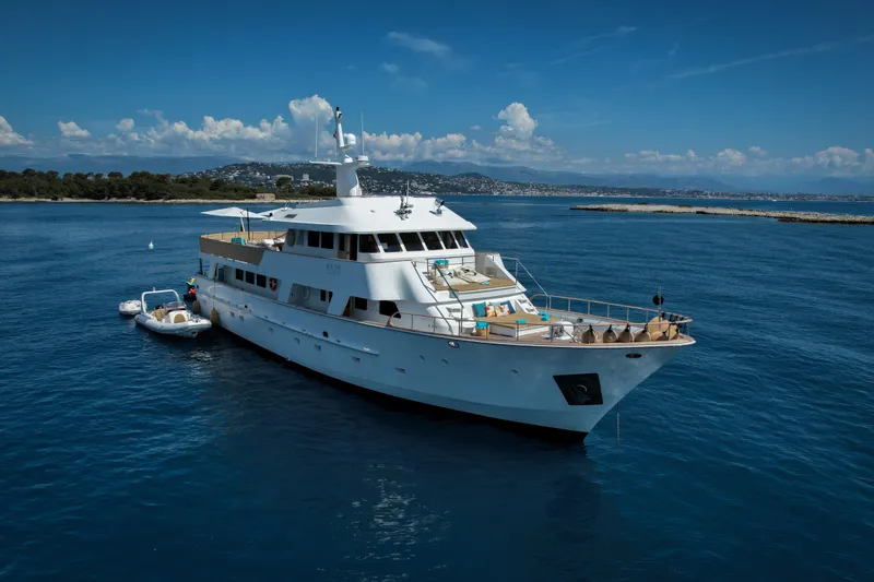 Eva Yacht Photos Pics Luxury 1993 Cheoy Lee Custom yacht anchored in serene blue waters.