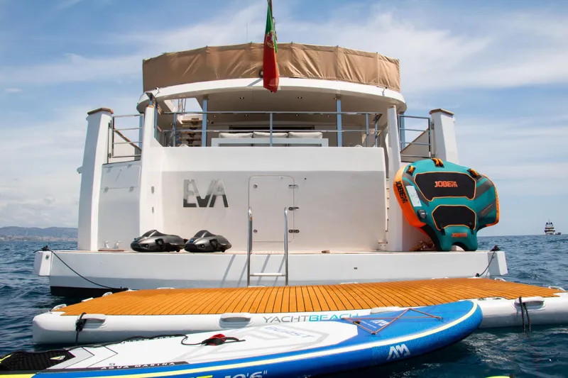 Eva Yacht Photos Pics 1993 Cheoy Lee Custom yacht with paddleboards and inflatable water toys on the ocean.