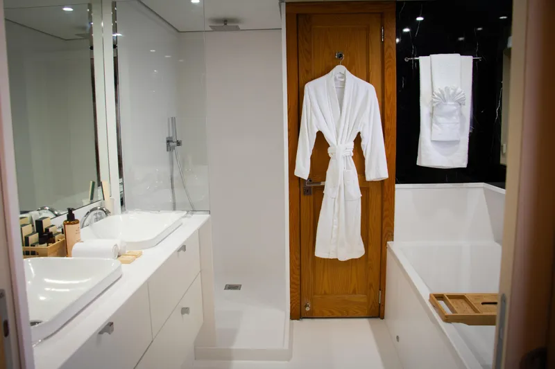 Eva Yacht Photos Pics Luxurious yacht bathroom with modern fixtures, white robe, and elegant decor, Cheoy Lee Custom 1993.