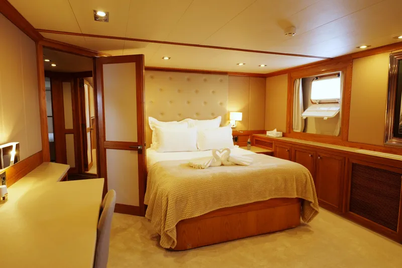Eva Yacht Photos Pics Luxurious 1993 Cheoy Lee Custom yacht bedroom with elegant decor and cozy lighting.