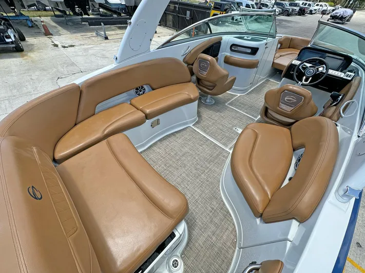  Yacht Photos Pics 2024 Crownline 290 XSS boat interior with tan leather seating and modern dashboard.