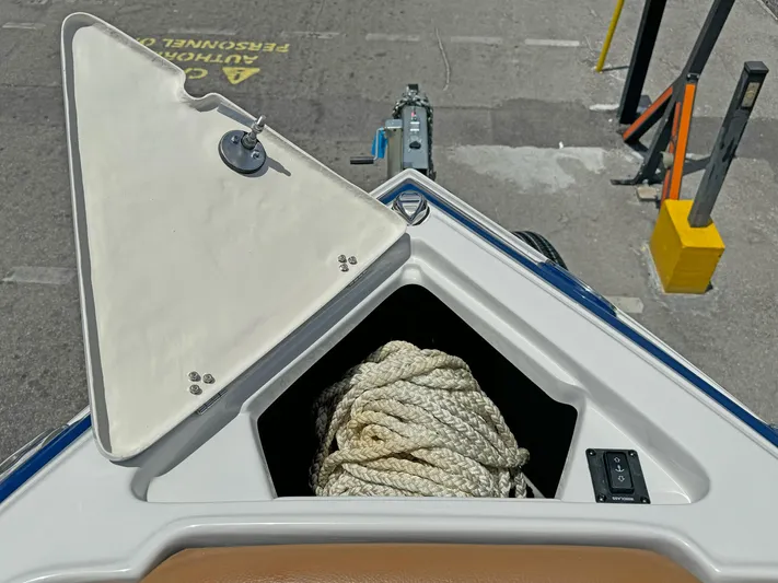  Yacht Photos Pics 2024 Crownline 290 XSS boat anchor storage with rope, dockside view.