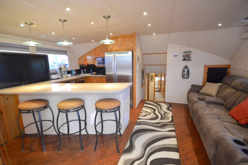 Hopium Yacht Photos Pics Luxurious 2004 Chesapeake 58 boat interior with modern kitchen and cozy seating area.