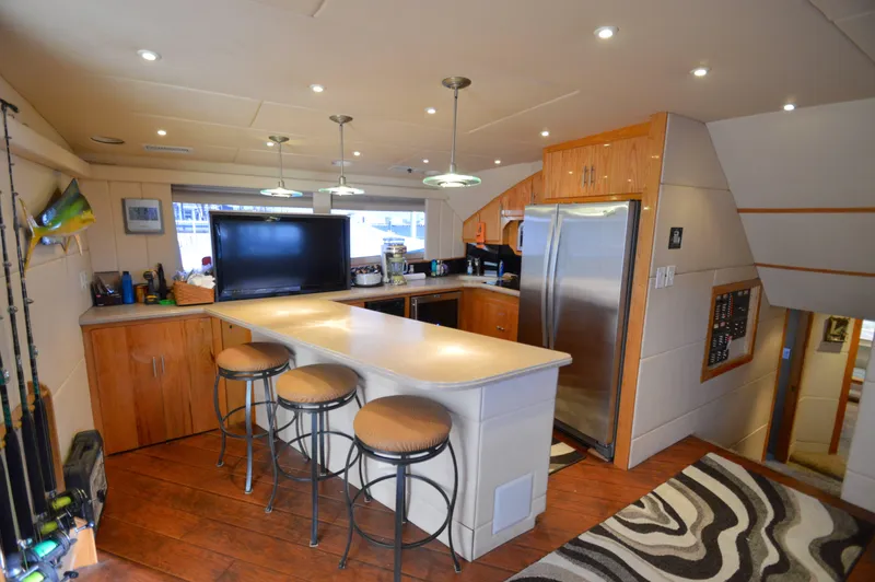 Hopium Yacht Photos Pics Luxurious 2004 Chesapeake 58 boat interior with modern kitchen and bar seating.