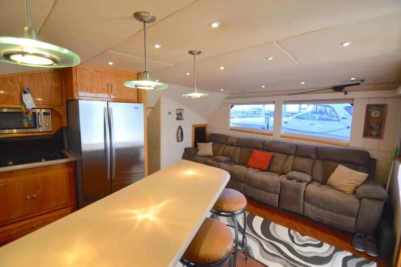 Hopium Yacht Photos Pics Luxurious 2004 Chesapeake 58 yacht interior with modern kitchen and cozy seating area.
