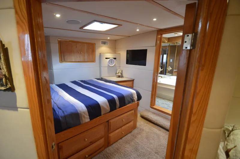 Hopium Yacht Photos Pics Luxurious 2004 Chesapeake 58 boat cabin with cozy bed and modern amenities.