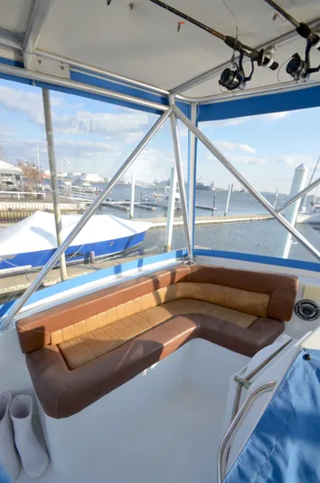 Hopium Yacht Photos Pics 2004 Chesapeake 58 boat interior with brown seating, overlooking marina.