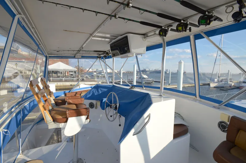 Hopium Yacht Photos Pics Interior view of 2004 Chesapeake 58 boat with helm and marina background.