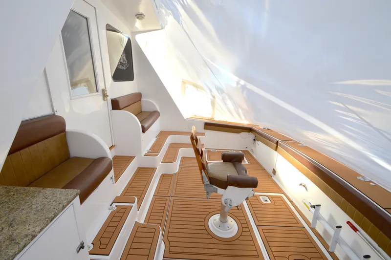 Hopium Yacht Photos Pics Luxurious 2004 Chesapeake 58 boat interior with teak flooring and comfortable seating.