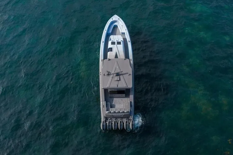  Yacht Photos Pics Aerial view of 2026 Midnight Express 52' Vitesse yacht cruising on clear blue water.