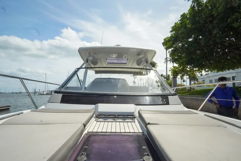  Yacht Photos Pics 2021 Jeanneau Leader 10.5 WA boat docked by the waterfront under a cloudy sky.