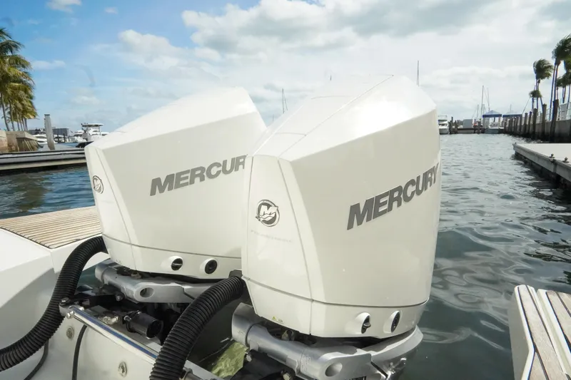  Yacht Photos Pics Twin Mercury outboard engines on a 2021 Jeanneau Leader 10.5 WA boat at a marina.