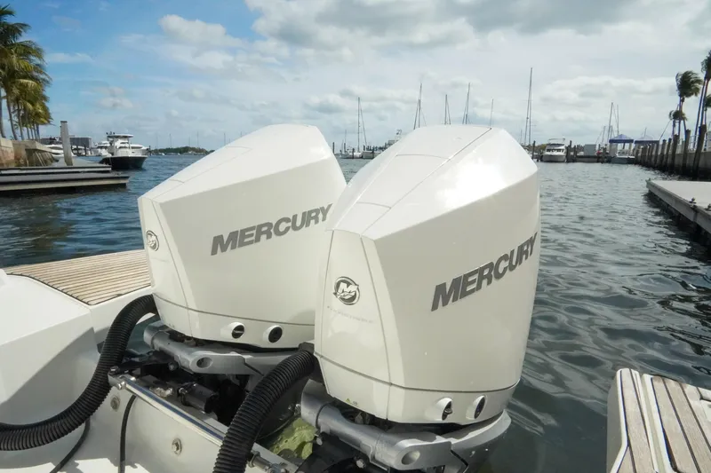  Yacht Photos Pics Twin Mercury outboard engines on a 2021 Jeanneau Leader 10.5 WA boat at a marina.