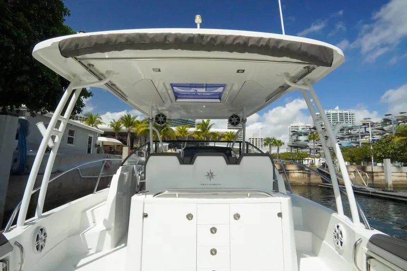  Yacht Photos Pics 2021 Jeanneau Leader 10.5 WA boat docked, showcasing spacious deck and modern design.