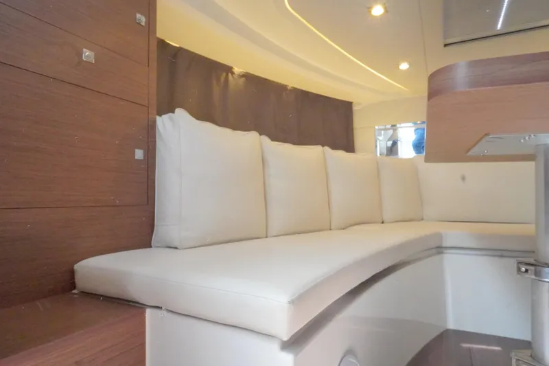  Yacht Photos Pics Interior of 2021 Jeanneau Leader 10.5 WA with white cushioned seating.