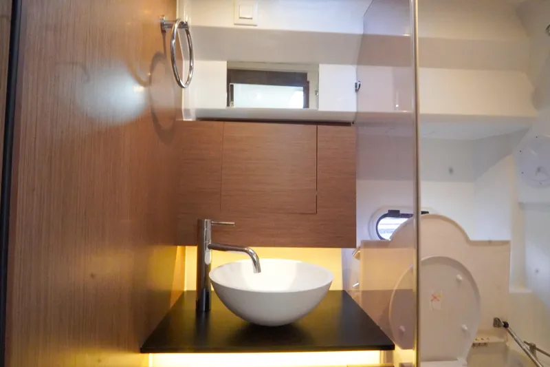  Yacht Photos Pics 2021 Jeanneau Leader 10.5 WA bathroom with modern sink and wooden cabinetry.