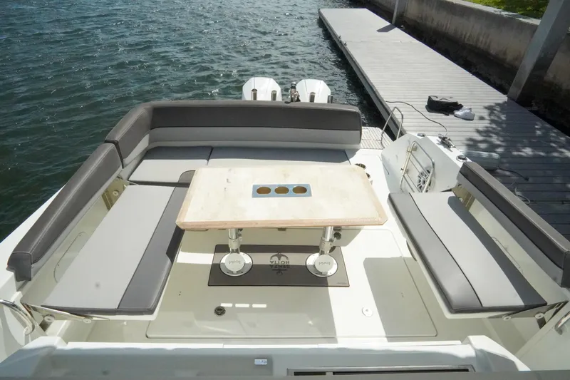  Yacht Photos Pics 2021 Jeanneau Leader 10.5 WA boat with spacious seating and table, docked by the water.