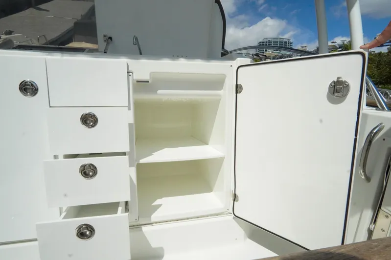  Yacht Photos Pics 2021 Jeanneau Leader 10.5 WA boat storage compartments with open shelves and drawers.