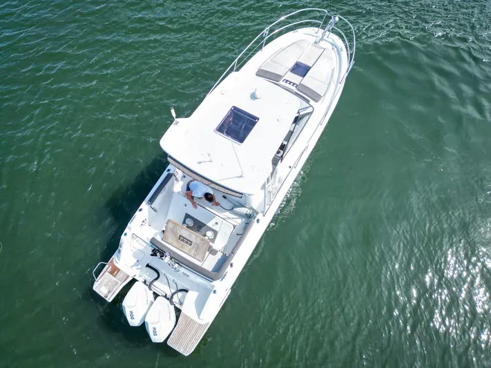  Yacht Photos Pics Aerial view of 2021 Jeanneau Leader 10.5 WA boat on calm water.