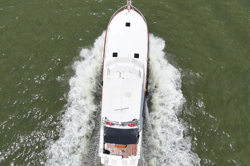  Yacht Photos Pics Aerial view of 1989 Buddy Davis 61 yacht cruising on green water.
