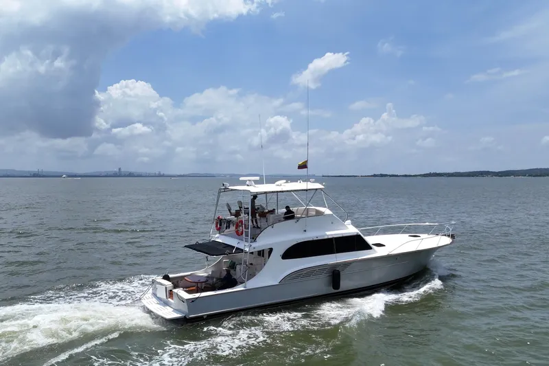  Yacht Photos Pics 1989 Buddy Davis 61 yacht cruising on open water under a partly cloudy sky.