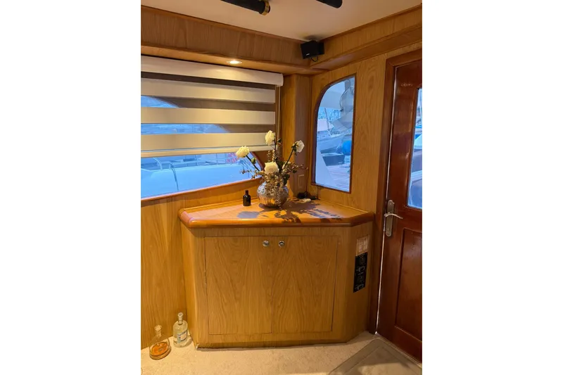  Yacht Photos Pics Interior of 1989 Buddy Davis 61 yacht with wooden cabinetry and floral arrangement.