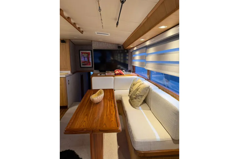  Yacht Photos Pics Luxurious interior of a 1989 Buddy Davis 61 yacht with elegant wood table and cozy seating.