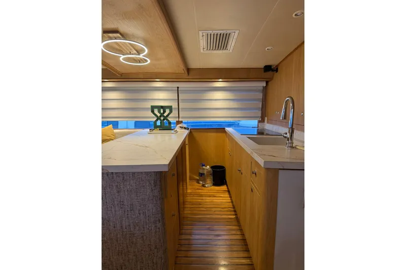  Yacht Photos Pics Interior of 1989 Buddy Davis 61 yacht with modern kitchen and wooden flooring.