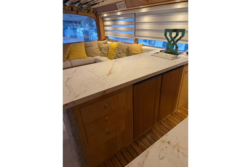  Yacht Photos Pics Luxurious interior of 1989 Buddy Davis 61 yacht with marble countertop and cozy seating.