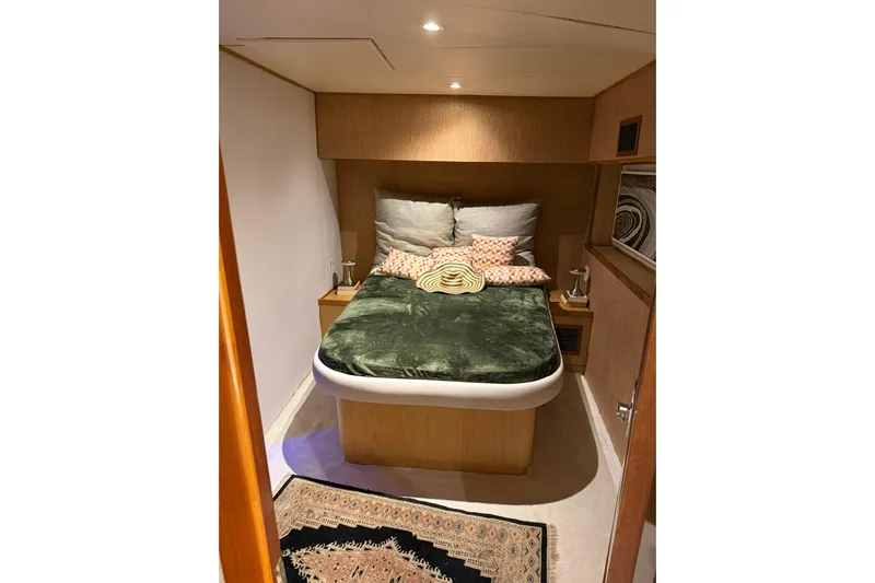  Yacht Photos Pics Cozy bedroom interior on 1989 Buddy Davis 61 yacht with plush bedding and warm lighting.