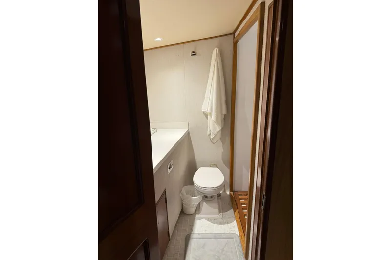  Yacht Photos Pics Bathroom interior of 1989 Buddy Davis 61 yacht, featuring toilet and towel.