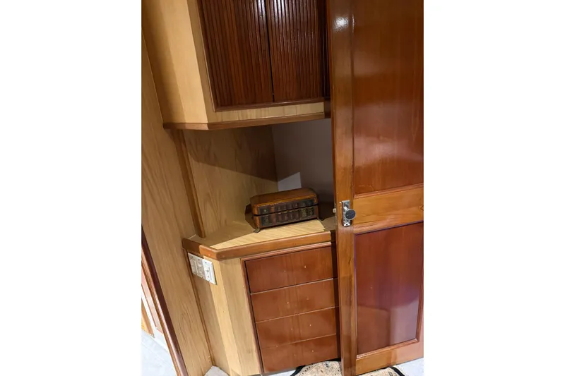  Yacht Photos Pics Wooden interior of 1989 Buddy Davis 61 yacht, featuring cabinets and drawers.
