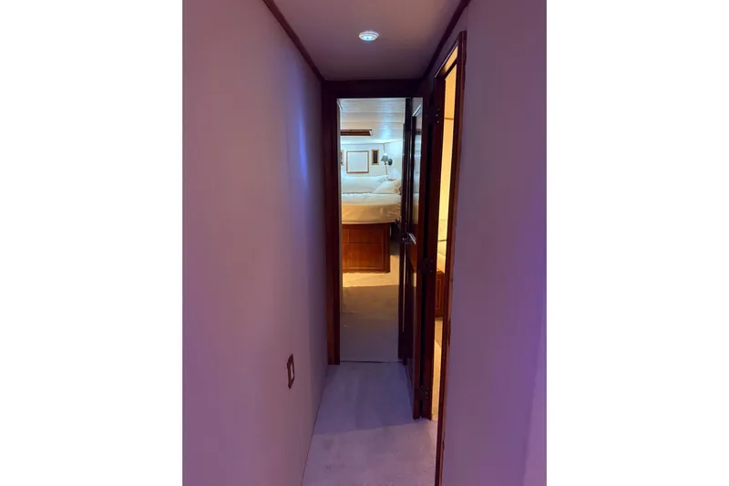  Yacht Photos Pics Narrow hallway leading to a cozy bedroom on a 1989 Buddy Davis 61 yacht.