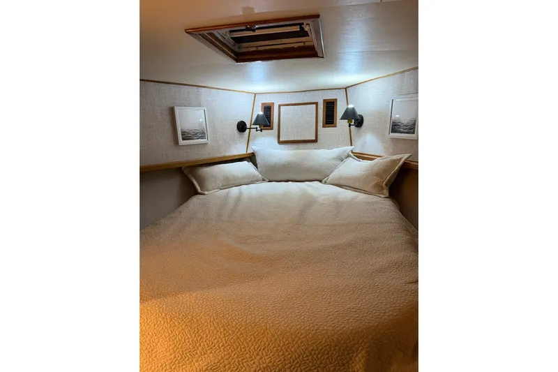  Yacht Photos Pics Cozy cabin bedroom in 1989 Buddy Davis 61 yacht with soft lighting and nautical decor.