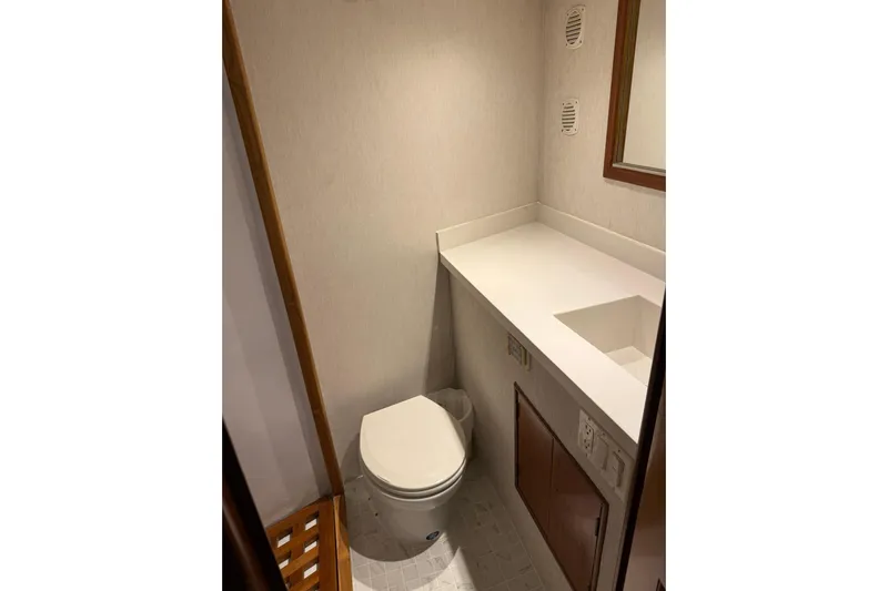  Yacht Photos Pics Bathroom interior of 1989 Buddy Davis 61 yacht, featuring toilet and countertop.